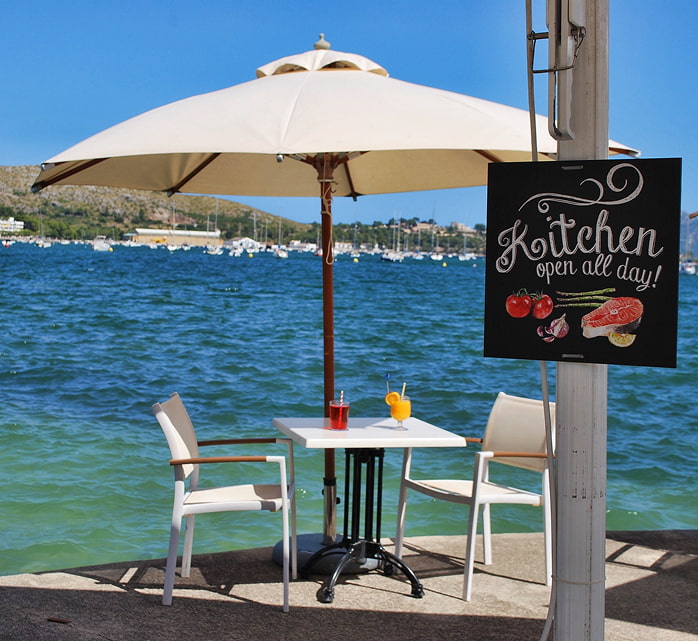 Table at Capri Restaurant & Bar Table with parasol at Capri Restaurant & Bar